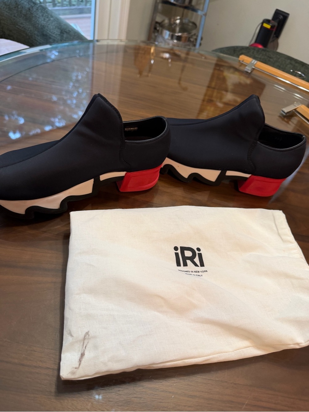 iRi Women’s Black Slip-On Sneakers with Red Heel Accent